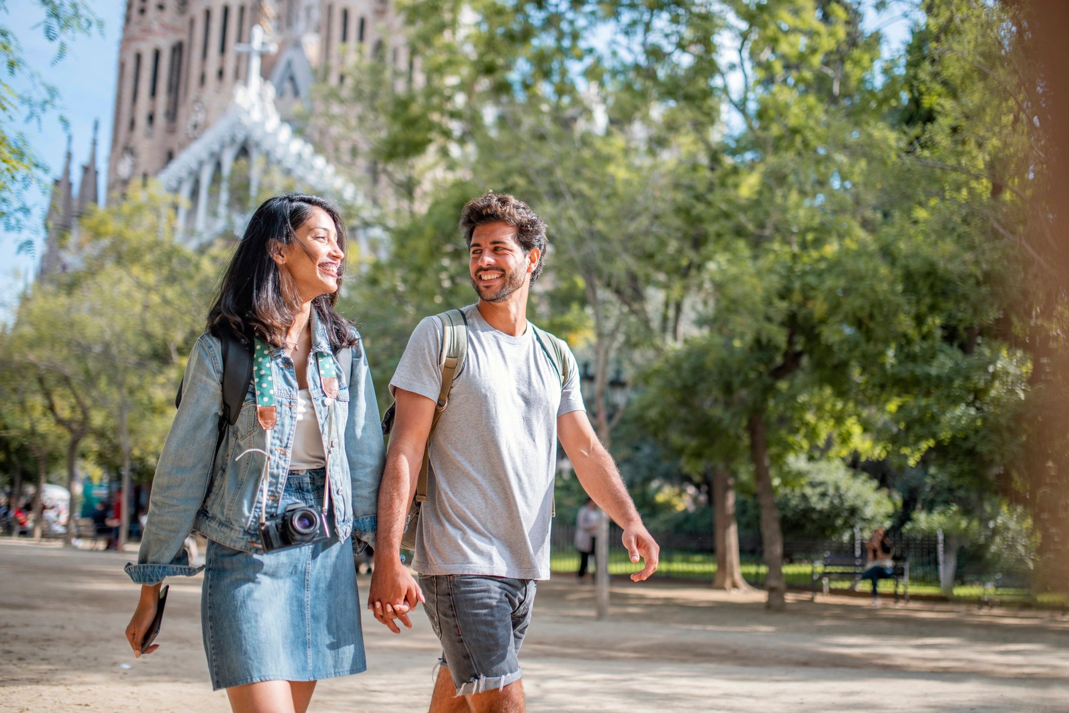 Vacationing Couple Walking Through Barcelona Public Park